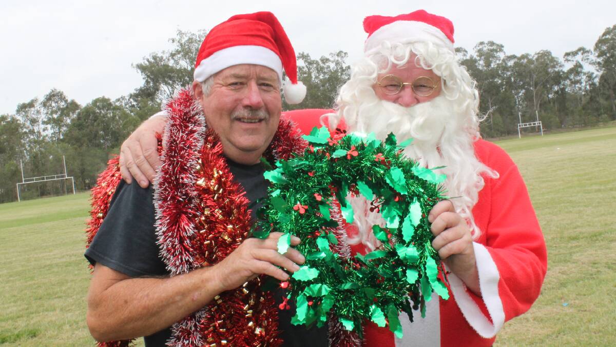 READY TO SING: Flagstone Community Association president Bob Wiley catches up with Santa ahead of the carols event planned for Flagstone next month.