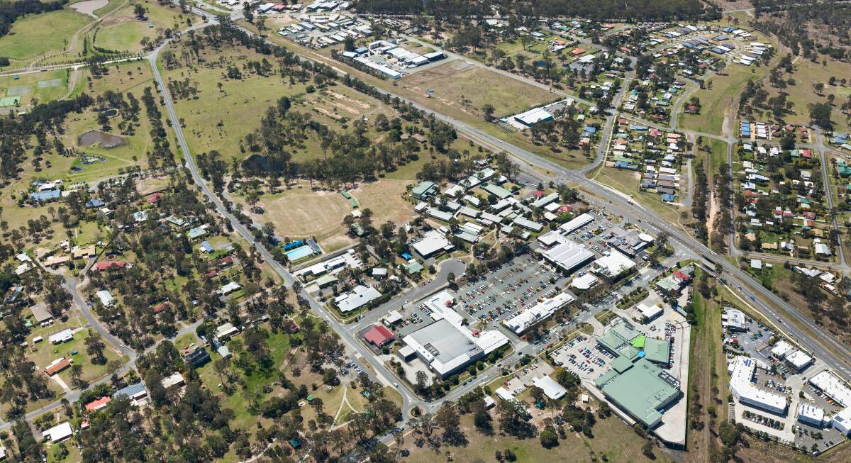SITES TO SELL: An aerial view of the existing Jimboomba Shopping Centre and the greenfield site north of Jimboomba State School.