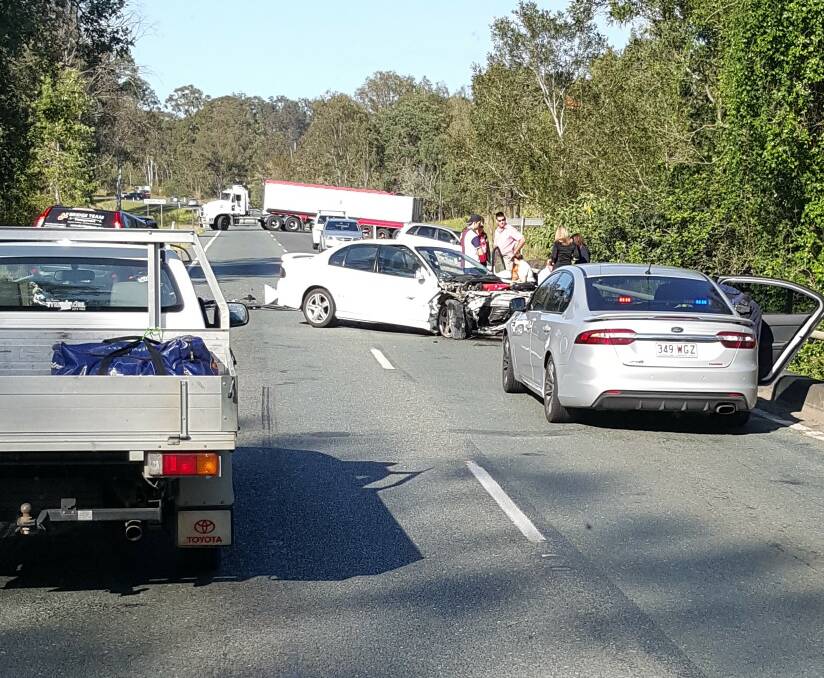 The crash scene moments after the collision between a white Holden Commodore and a Nissan X-Trail.