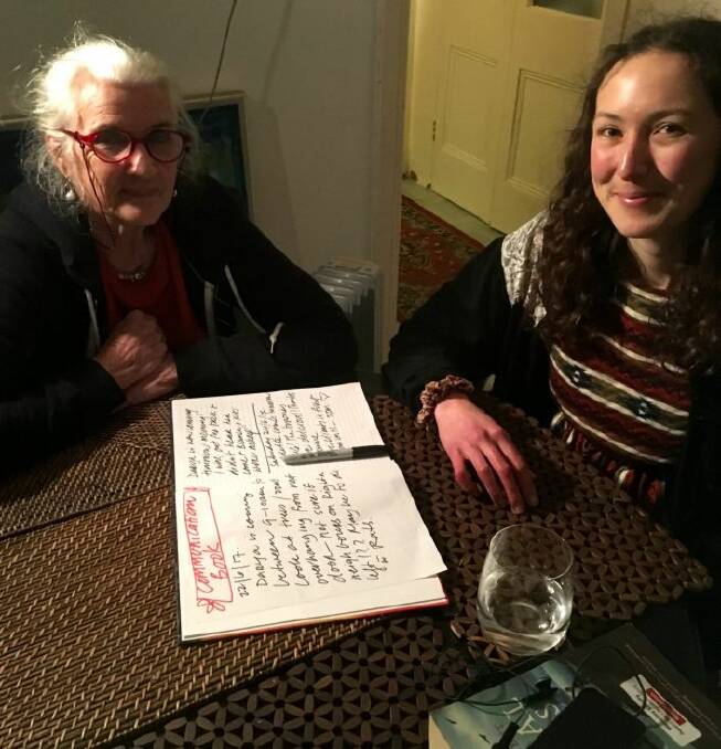 Marie Theodore-Daly, 73, with housemate Jasmin, 25, and their communication book.

