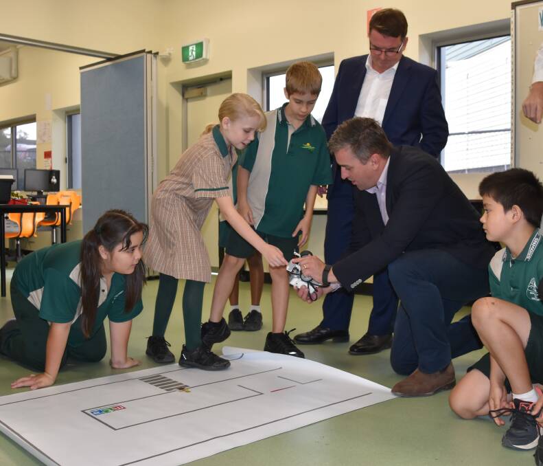 FUTURE: Logan mayor Luke Smith and state member for Logan Linus Power were at Browns Plains State School today to announce a program which will introduce residents to coding and robotics, and will be delivered through local libraries. Photo: Supplied.