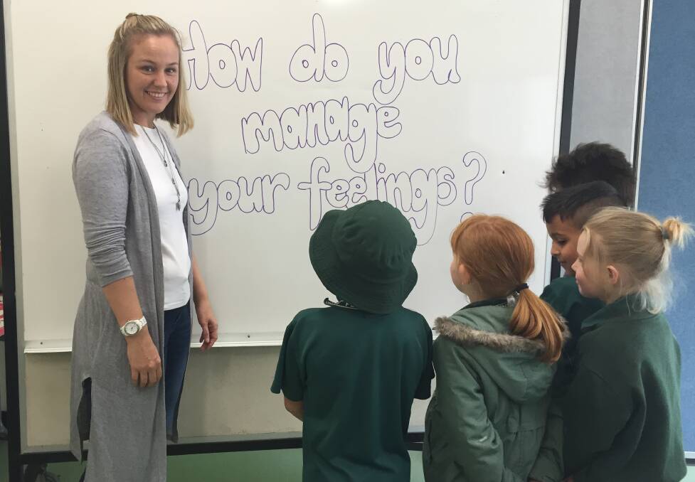 CLUB: YFS' Jessica Jackson works with a group at Browns Plains State School. Photo: Christine Rossouw