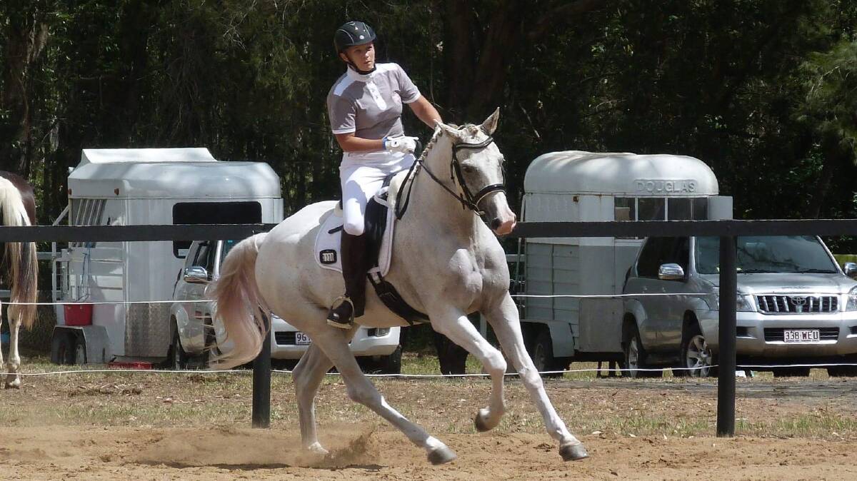Getting ready: Karen Spencer rides mount Breeze Thunder Struck in the warm up area on Sunday. Photo: Supplied