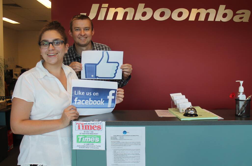 THUMBS UP: Jimboomba Times journalists Georgina Bayly and Joshua Paterson were among the staff who celebrated the Times Facebook page hitting 5000 likes last week.