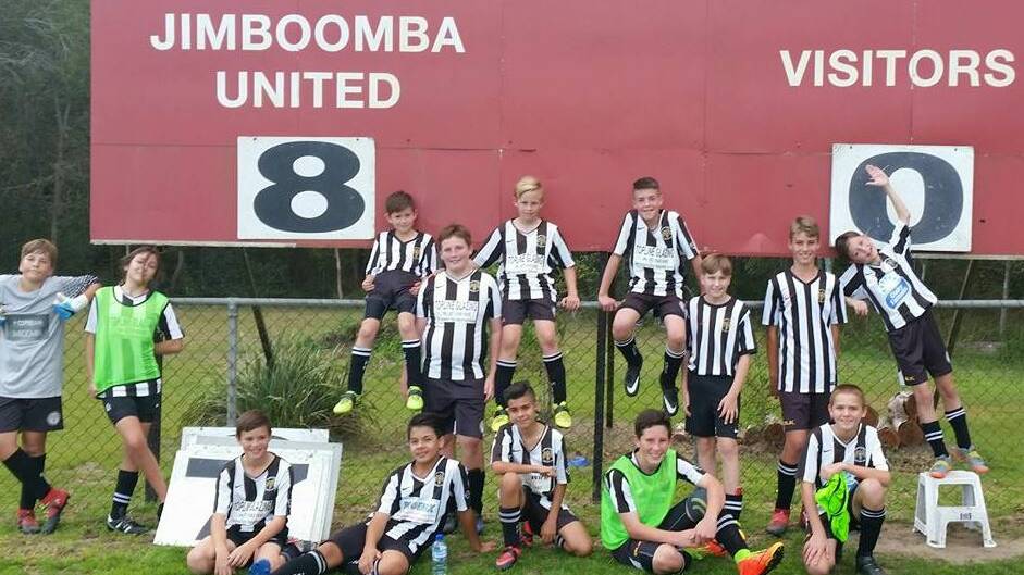 Winners are grinners: The Jimboomba team take a moment to remember the score. Photo: Supplied