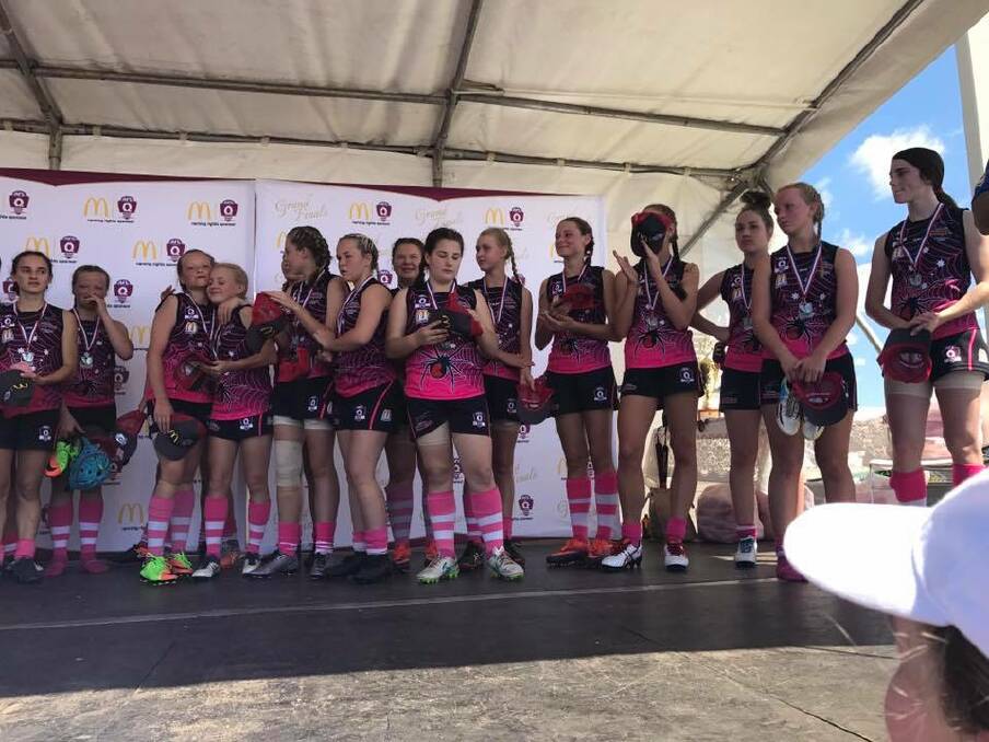Season's end: The Jimboomba Redbacks under 15s girls' team stands on stage after receiving their runners-up medals. Photo: Supplied