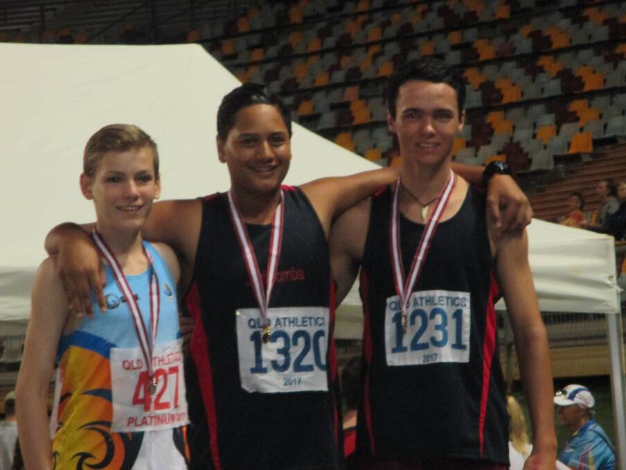 Tama Tupaea centre and Sam Windsor right who won gold and bronze in the under 15 boys discus.