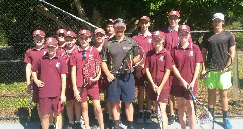 Passing on his knowledge: Tennis coach Brett Day with some of his Kooralbyn International school students. Photo: Supplied.
