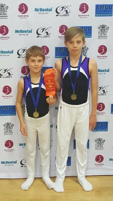 Two of Jimboomba's Men's Artistic Gymnastics competitors with their medals from the Caloundra competition.