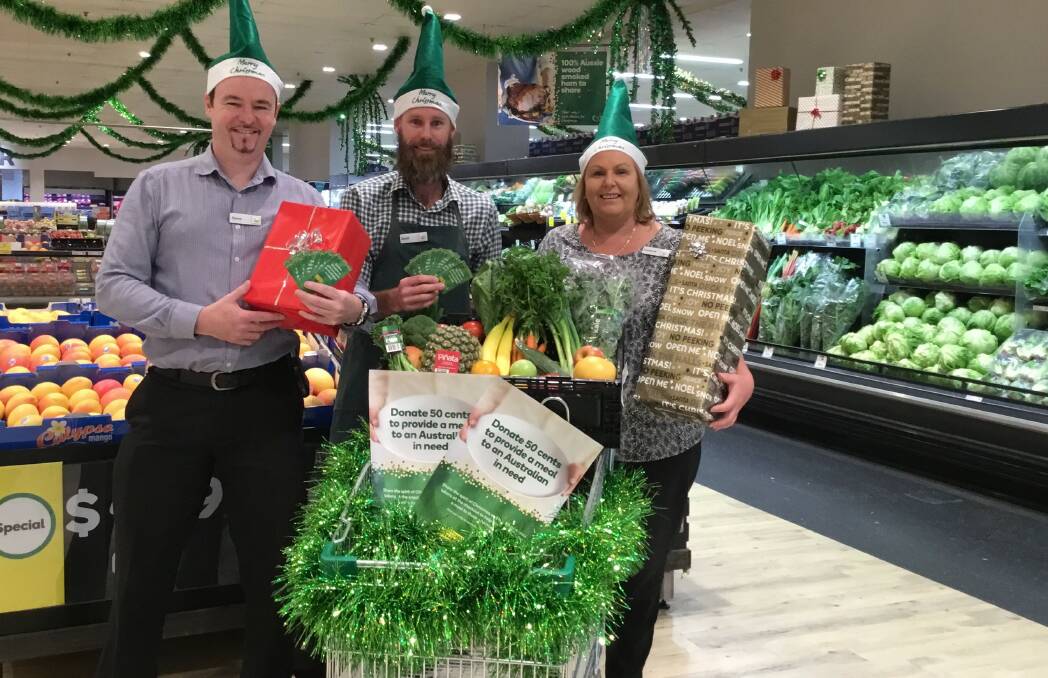 CHRISTMAS SPIRIT: Browns Plains Woolworths assistant store manager Steve Lewis, produce team leader Brett Hardy and store manager Vivienne Schreiber.