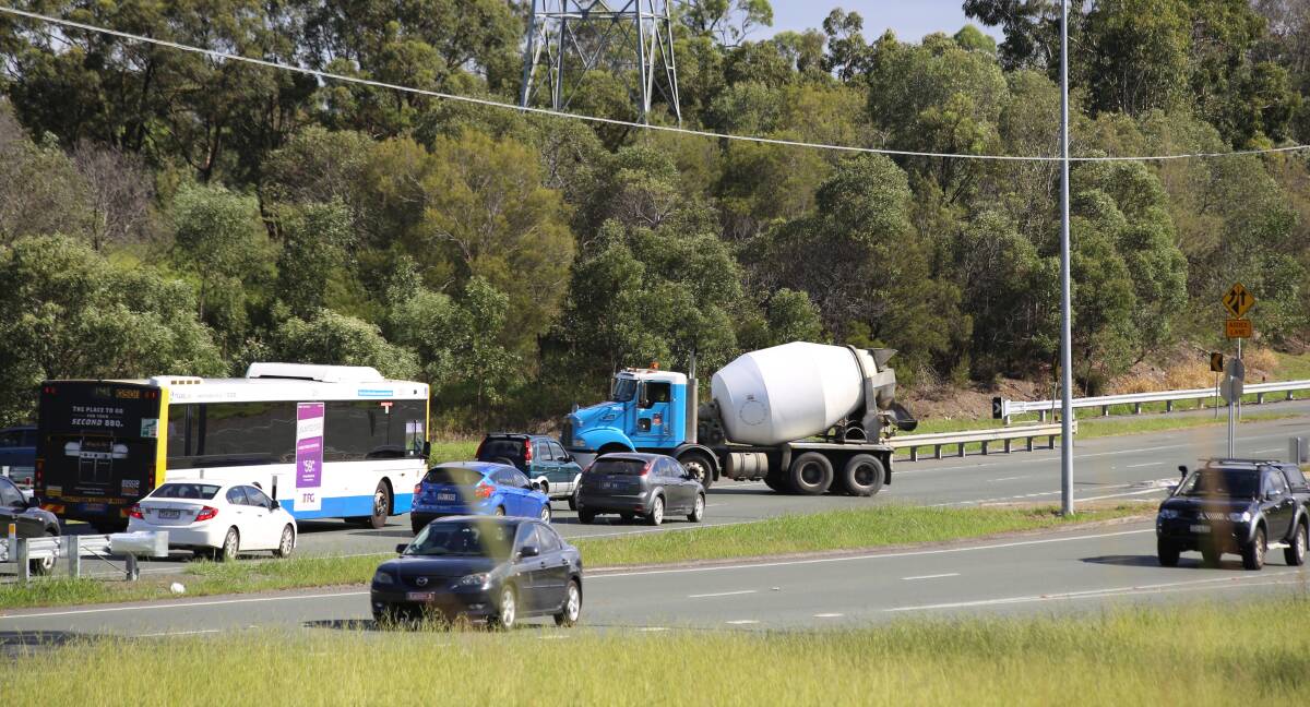 Giving way: Traffic stops to allow a cement mixer across the Mount Lindesay Highway at the Logan Motorway interchange. Photo: Stan and Suz Corbett