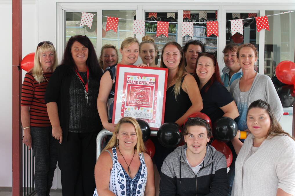 CELEBRATION: Parents and Citizen's Association volunteers who assisted with the new tuckshop were presented with a frame at a ribbon-cutting ceremony at Cedar Creek State Primary School. Photo: Supplied
