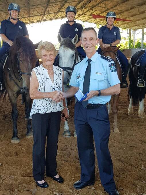 Inspector David Kolb of the Specialist Services Group presented Heather Crack with a medal. Photo: Supplied.