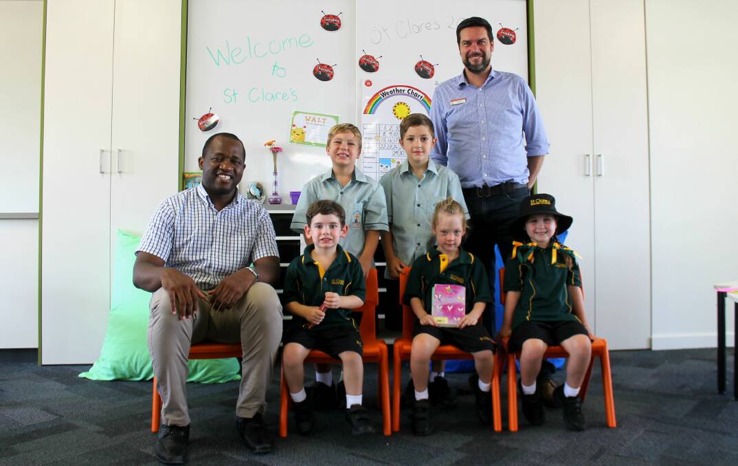 OPEN: St Clare's pupils were eager to put on their new school uniforms and settle into Yarrabilba's first primary school this week. Photo: Georgina Bayly