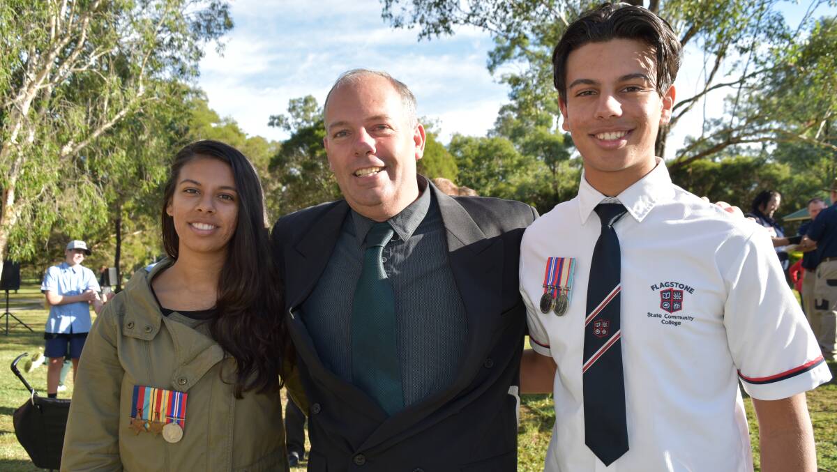 LEST WE FORGET: The Bartlett family - Nakita, 18, with her father Ian and brother Krishan, 16. Both teens WWII medals earned by their grandfather and great grandfather. Their great grandfather helped defend Malta while their grandfather was involved with the Royal Australian Air Force. Photo: Hannah Baker 
