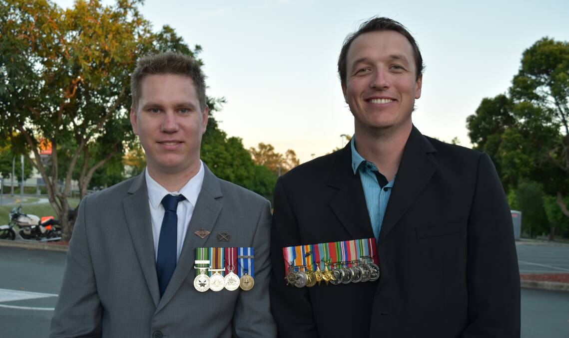 LEST WE FORGET: Marsden man David Smith was deployed to Afghanistan in 2012 with the Australian Army as a combat engineer. His friend Reiner Mantei, of Springfield Lakes, proudly wears his grandfather's WWI and WWII medals. Mr Mantei said his grandfather, Joseph Hibbs, went to Gallipoli aged 16 and was deployed to Japan in WWII. Photo: Hannah Baker