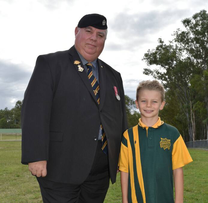RESPECT: Jimboomba and Districts Cadets' Brett McCreadie with Jimboomba State School year three student Ethan Eagle. Photo: Hannah Baker
