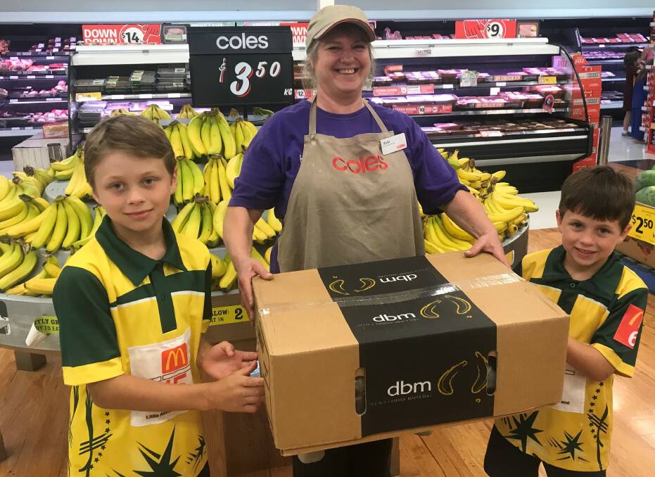 BANANA POWER:   Orlando Pharaoh, Vicki Domjahn and Roman Pharaoh discover the power of the simple banana at Coles Jimboomba.  Coles is a significant sponsor of Little Athletics by providing boxes of bananas to the Jimboomba club on a weekly basis.