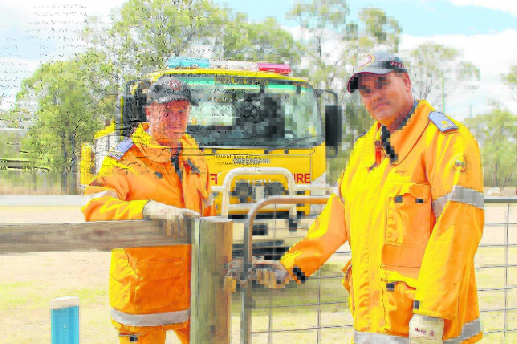 Firefighter Sean Gibson and third officer Kyle Chamberlain of the Greenbank Rural Fire Brigade are reminding residents large trucks might need access to their properties in the 
event of a bushfire.