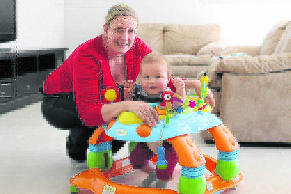 Cedar Vale mother Carlie Ross, with eight-month-old son Oliver, says means testing of the childcare rebate would hurt her family's budget.