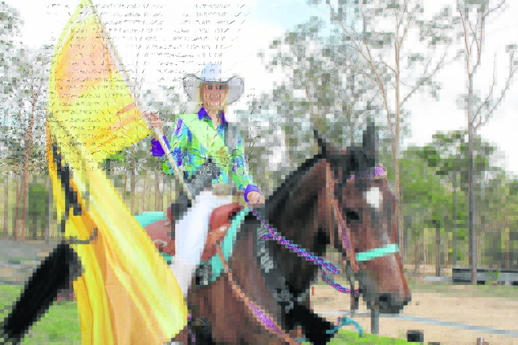 North Maclean's Tahliah Pugsley trains her horse Oscar to walk with a flag.