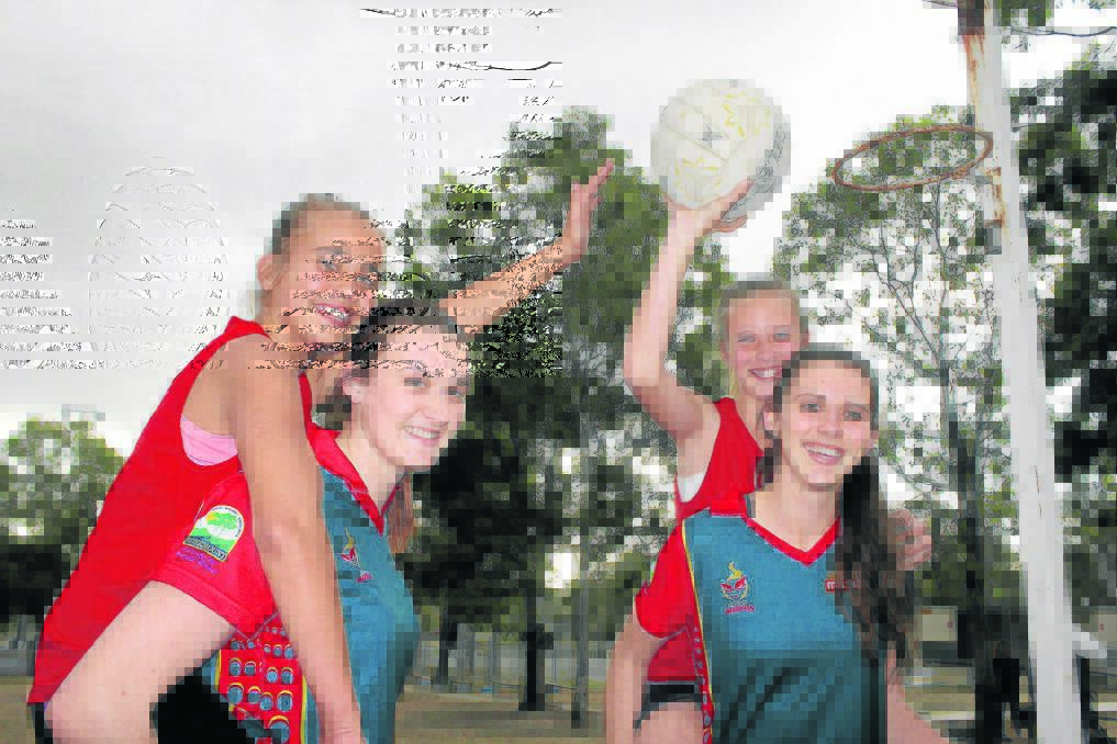 Logan Wildcats players Allie, 16 and Jordan Waugh, 19, give Chloe Thiele, 11, and Lori Barron, 11, a boost in the Wildcats Cubs junior development program.