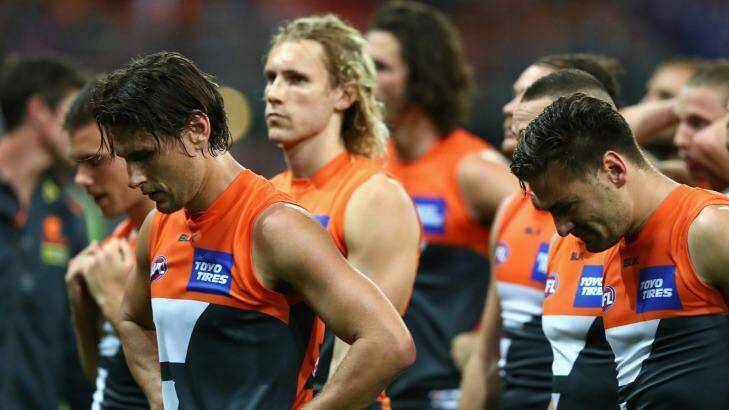 Shattered: Giants players looks dejected after being defeated by the Western Bulldogs. Photo: Ryan Pierse