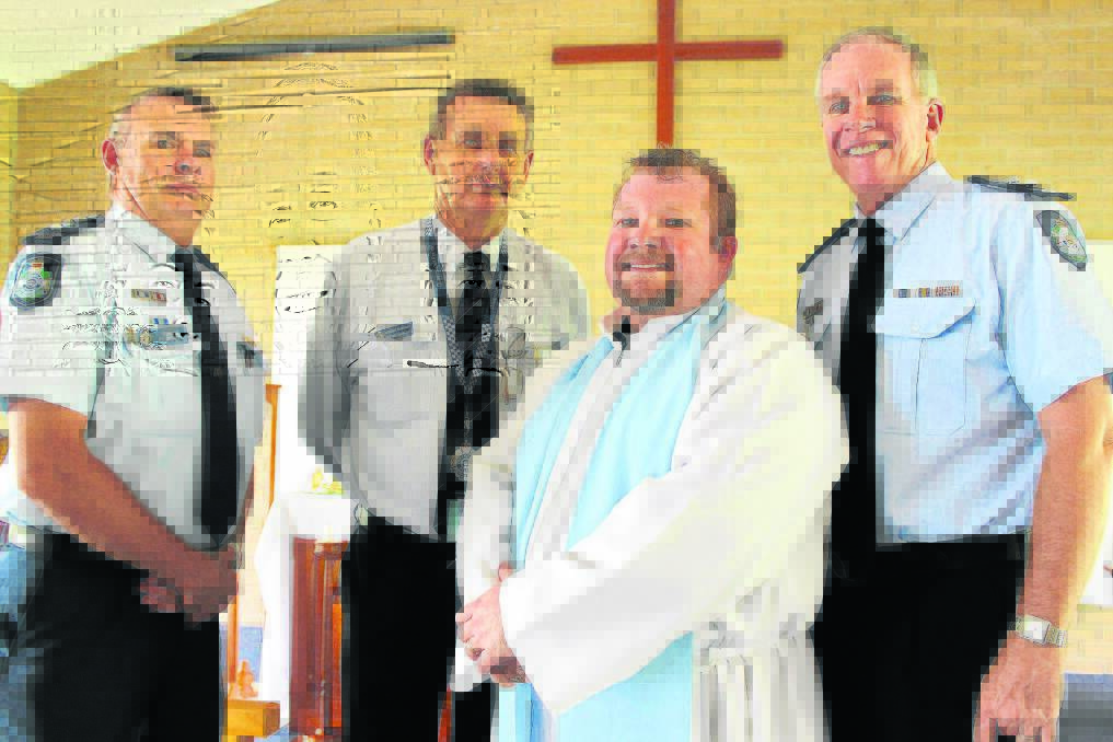 Western Patrol Group Inspector Pat Swindells, Senior Chaplain Graeme Ramsden and Acting Chief Superintendent Noel Powers congratulate Father Dan Talbot on his induction as a police chaplain.