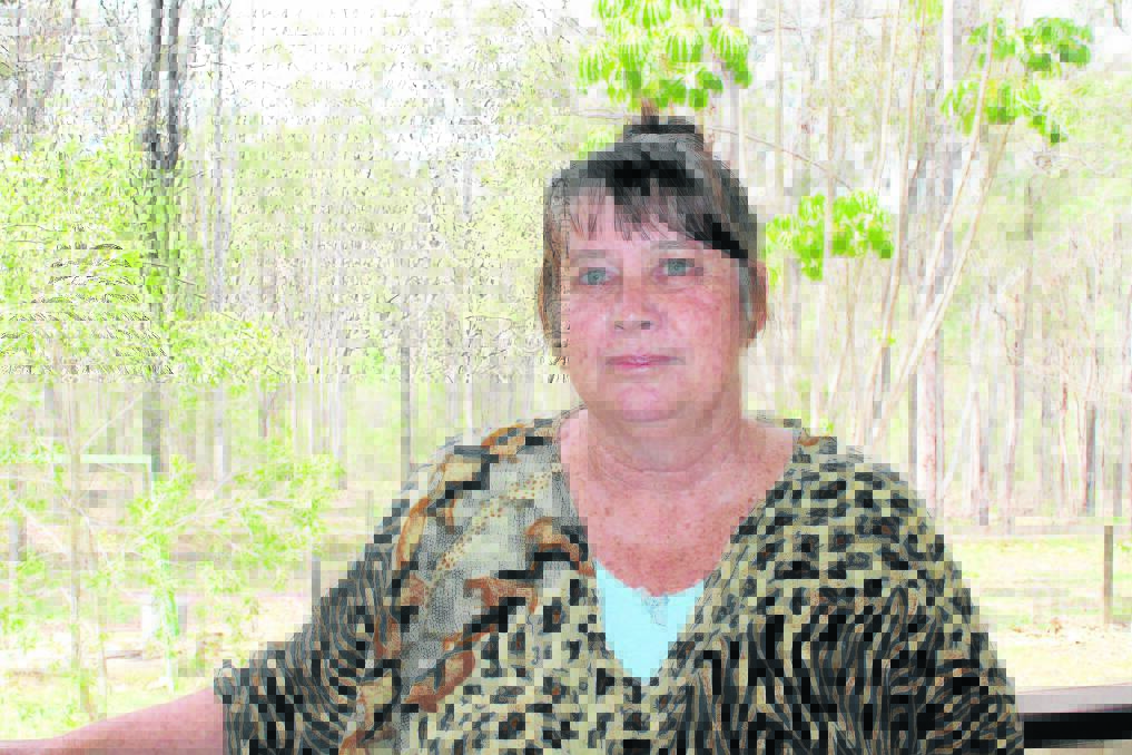 Jimboomba resident Lyn Suffolk said her family is as prepared as possible for bushfire season. Inset: fire crews do a hazard reduction burn on the Suffolk property in Jimboomba.