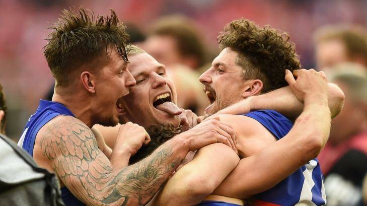 Lapping it up: Bulldogs Clay Smith, Jake Stringer, Luke Dahlhause and Tom Liberatore celebrate their win for the ages. Photo: Justin McManus