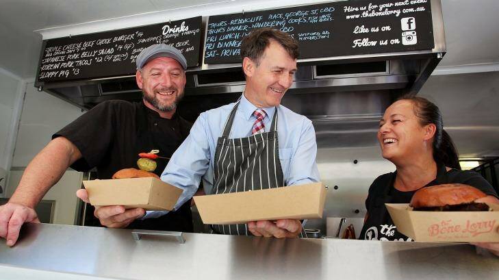 Lord Mayor Graham Quirk on board the Bone Lorry food truck with owners Joel Chrystal and Eileen Taylor-Chrystal. Food trucks have proven to be 'exceptionally' safe, Cr Quirk says. Photo: Lisa Maree Williams
