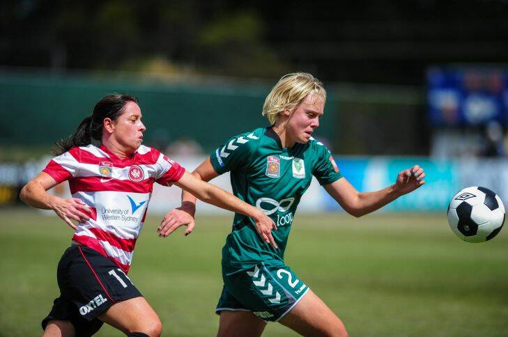 Sport: Canberra United has its first home game of the year against Western Sydney Wanderers at McKellar Park. Catherine Brown of Canberra United and Michelle Carney of Sydney Wanderers in action. 17th of November 2013. Canberra Times Photograph by Katherine Griffiths
