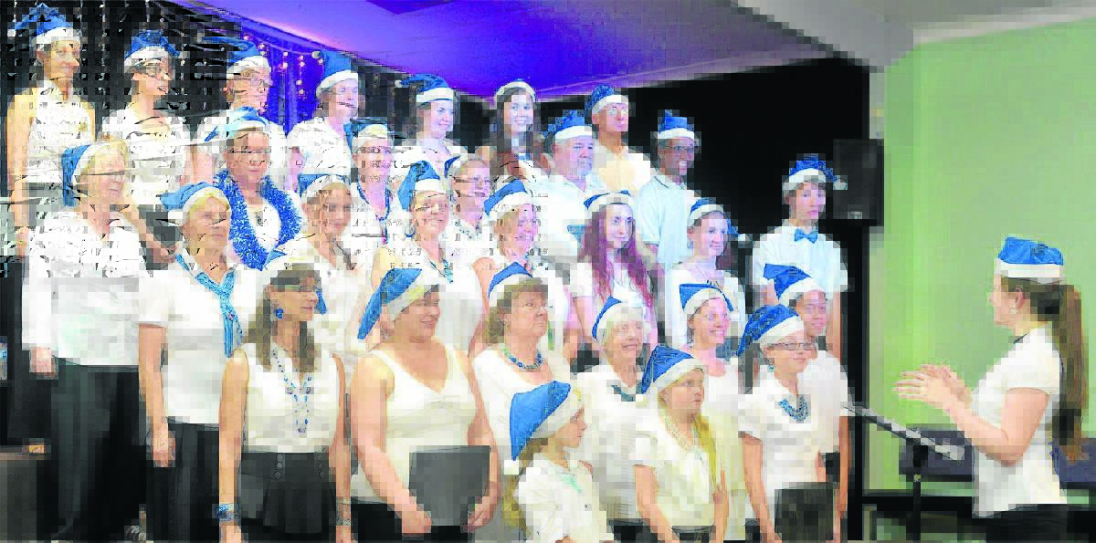 The JC Family Church and The Music Spot Choir practice for the Jimboomba Christmas Carols 
at their recent dress rehearsal.