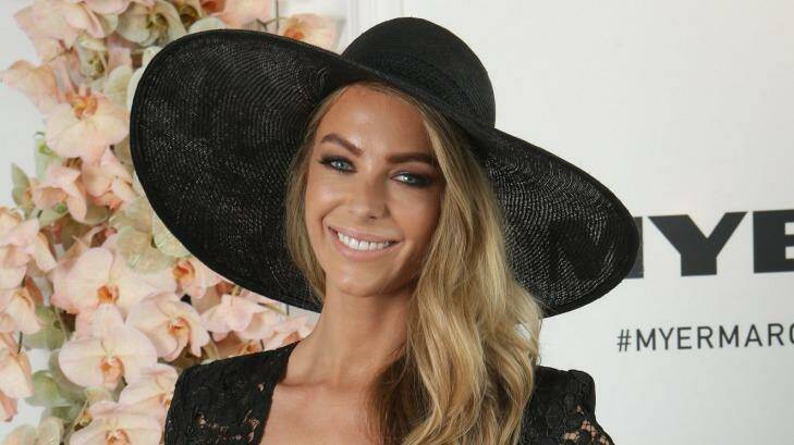 Jennifer Hawkins wore a sun hat to brave the cool conditions at Derby Day.