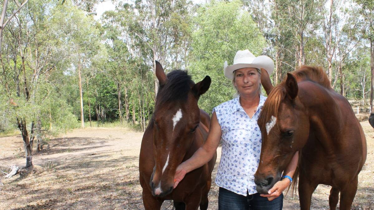 Jimboomba woman Beatrix Bergman with her beloved horses Oaky and Lilly, is urging motorists to slow down and be aware of others on the road.