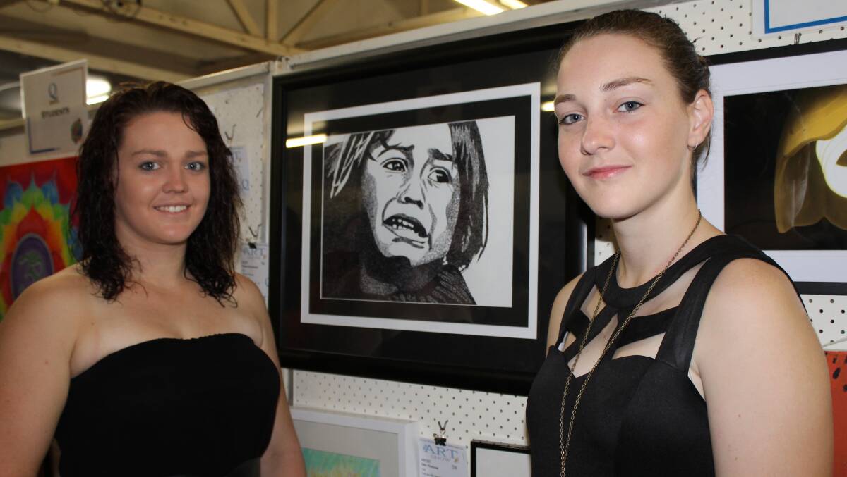 Michaela Manzelmann admires her 16-year-old sister, Brianna Manzelmann's entry in the student category. 