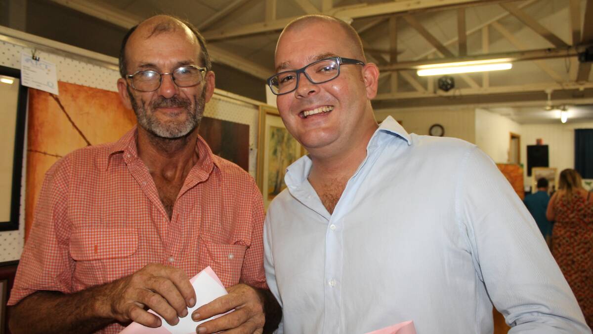 Brian Legge of Greenbank and Oliver Tyres of the Gold Coast admire the wide variety of art on show.