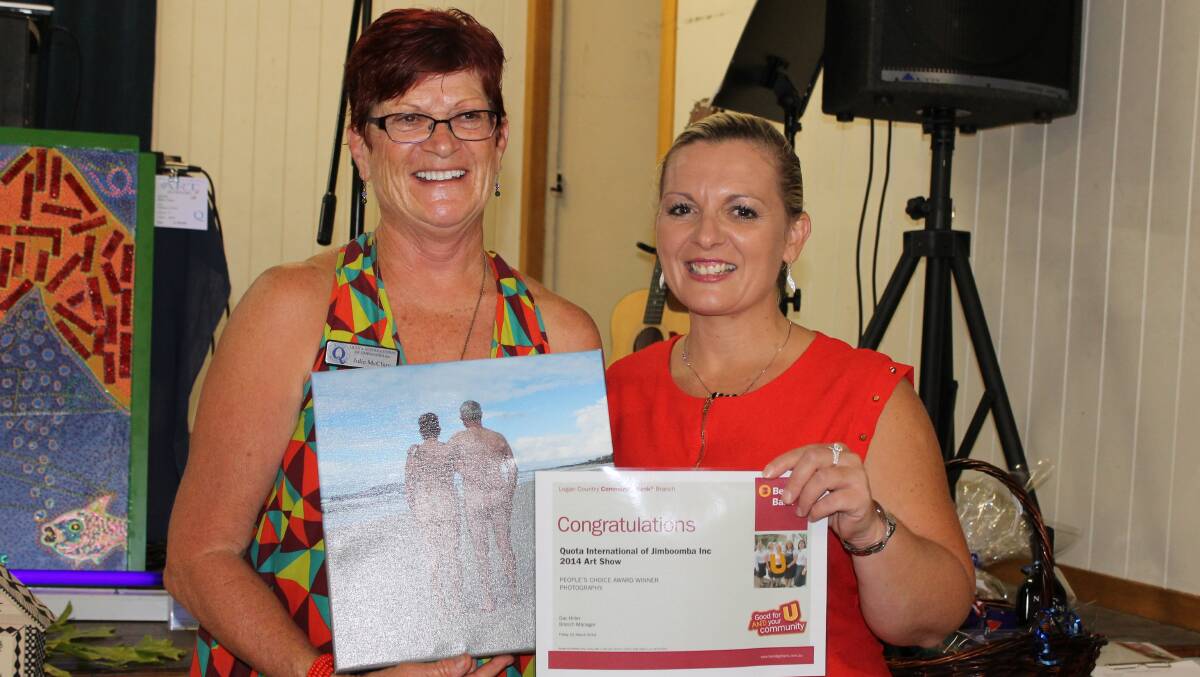 Art Show organiser, Julie McLure accepts the People's Choice Award from Gay Hider, on behalf of her fiance Andrew Burwell for his photo, Beach Bums.