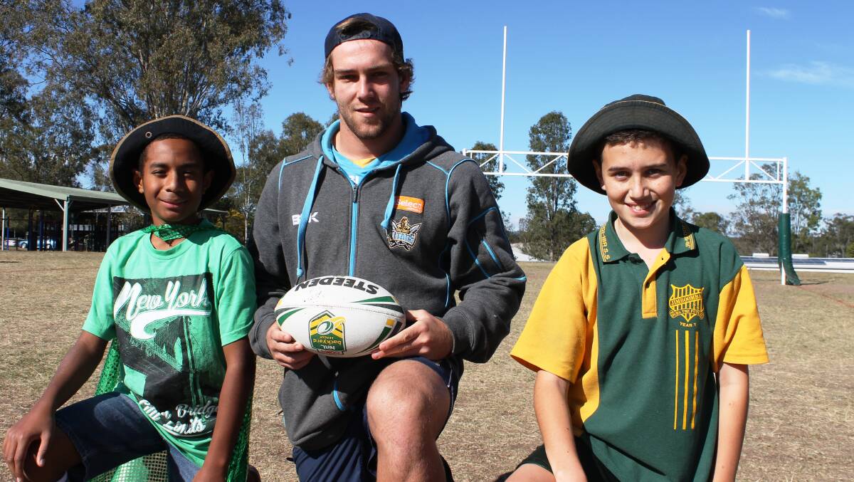 Jimboomba State School students Aydan Joku, 12, and Ryan Murley, 12, with under 20s Gold Coast Titans player Anthony Colman, had fun improving their rugby league skills during a development session.