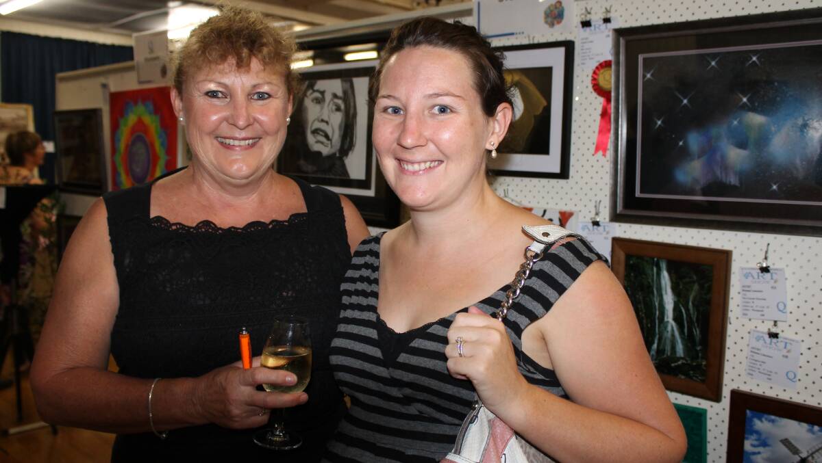 Photographer Kayleen Wilikie and her daughter Teneale, of Jimboomba, enjoy the Quota Art Show's opening night. 