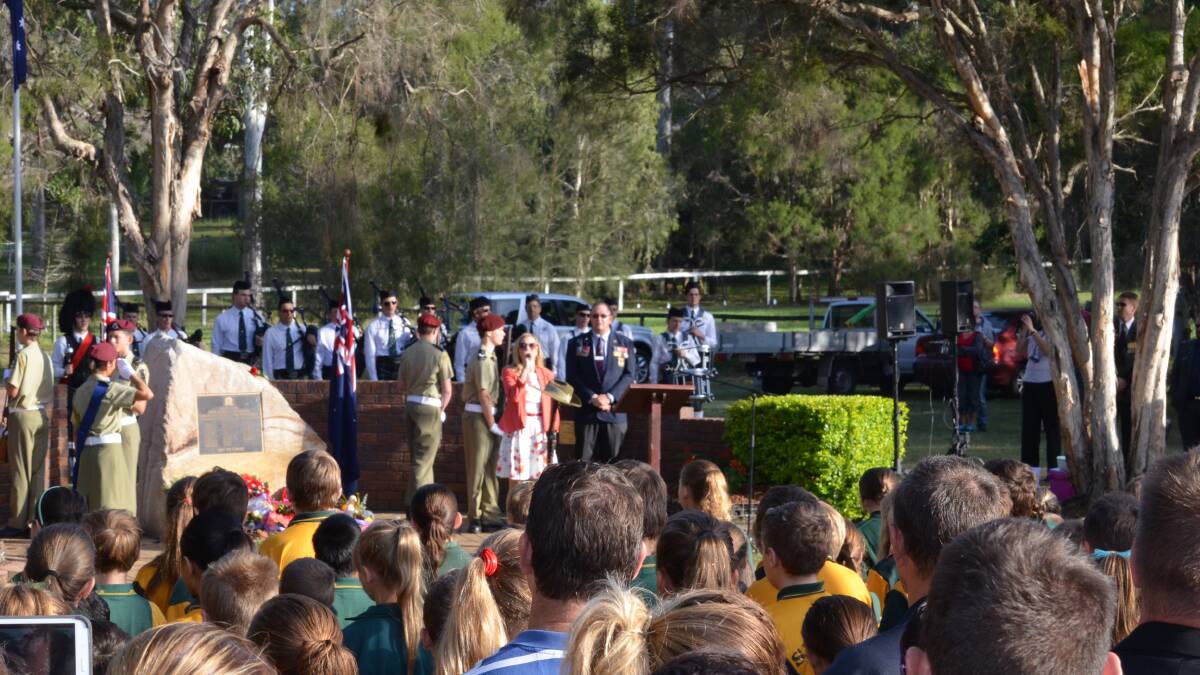 Michelle Hampson sings Advance Australia Fair during the ceremony at Jimboomba