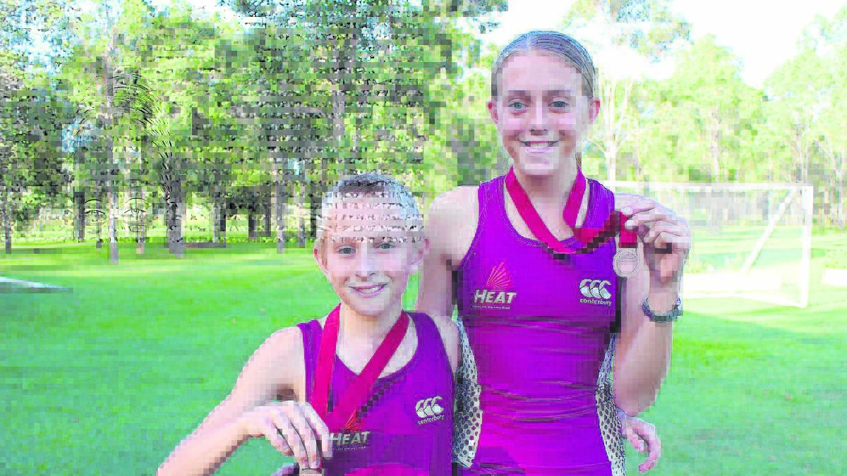 Shane and Chloe Bradley display the bronze medals they won at the Queensland State Championships.