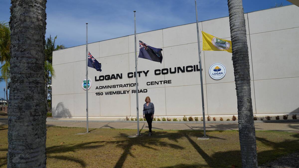 Mayor Pam Parker inspects the flags flying half-mast at Logan City Council today in honour of former Queensland premier Wayne Goss who died on November 10.