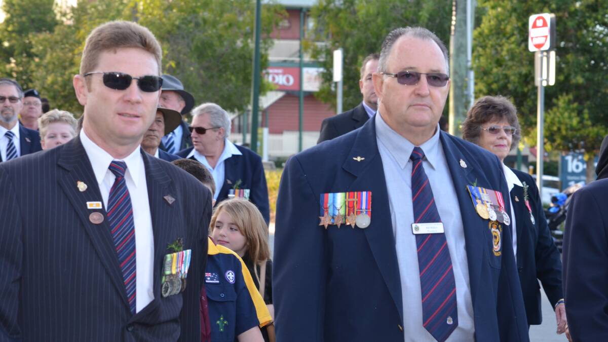 Jimboomba RSL sub-branch vice president Marcus Bruty and president Bill Malkin march along Cuscak Lane.