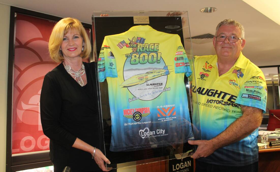 Mayor Pam Parker receives Logan's honorary "crew shirt" from New Beith man and land speed record holder Trevor Slaughter.