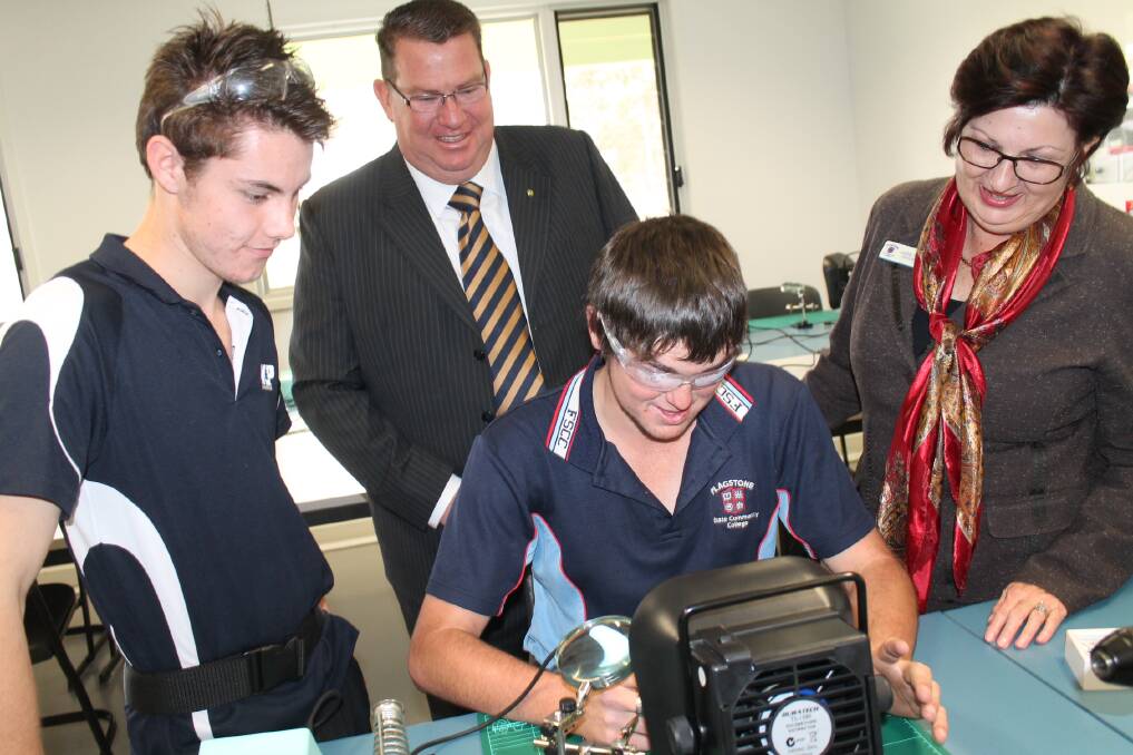 Member for Wright Scott Buchholz, Flagstone State Community College principal Jude Fox and year 12 students Brad Hodkinson and William Brady, who are completing their Certificate II in Electrotechnology.