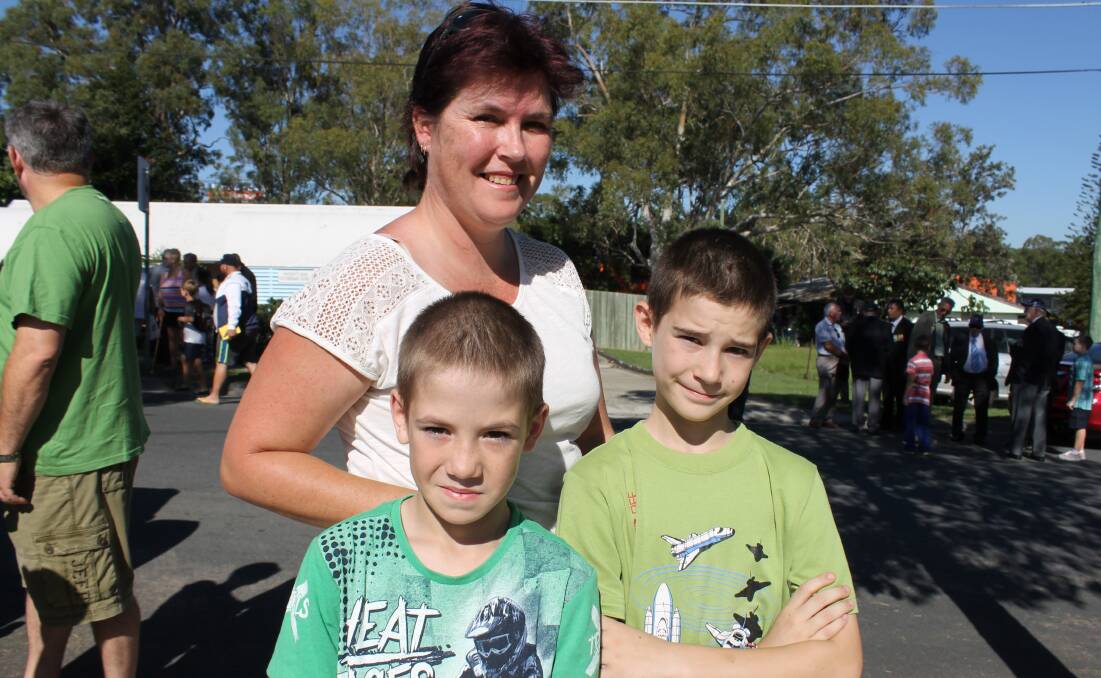 Sharon Fenlon of Woodridge, with her two children Benji and Christopher, travelled to watch her three other children march in the parade.