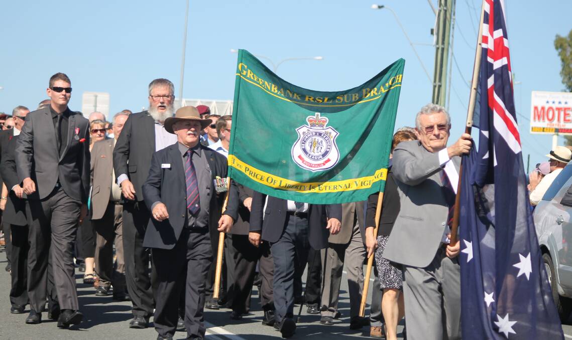 Greenbank RSL sub-branch president Barry Macdonald leads the sub-branch veterans in the march.
