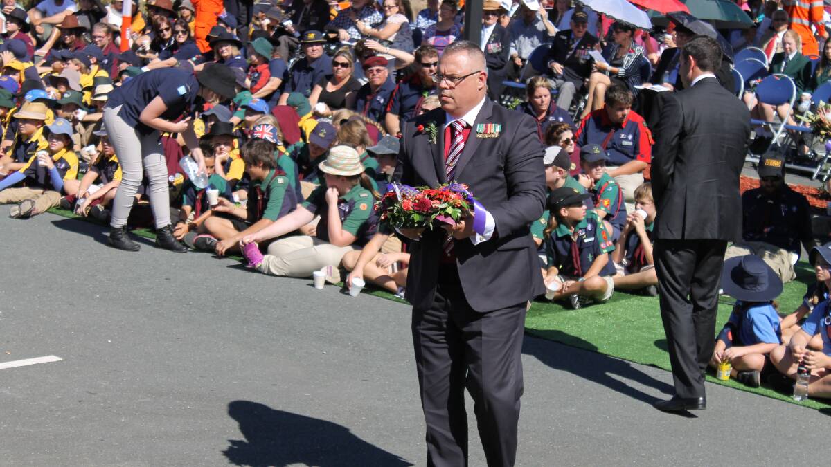 Logan MP Michael Pucci lays a wreath at the Anzac Day service.