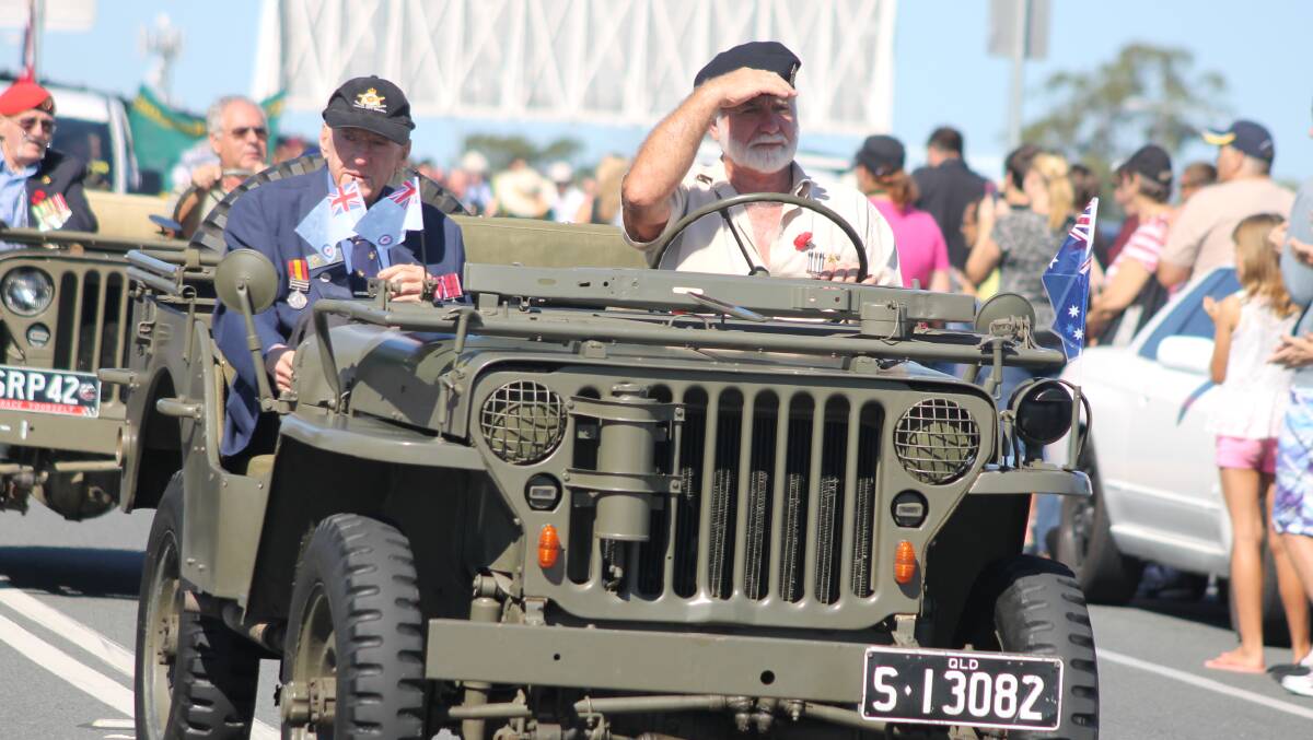 Greenbank RSL sub-branch veteran Reg Smith (seated in back of truck) rides at the front of the parade.